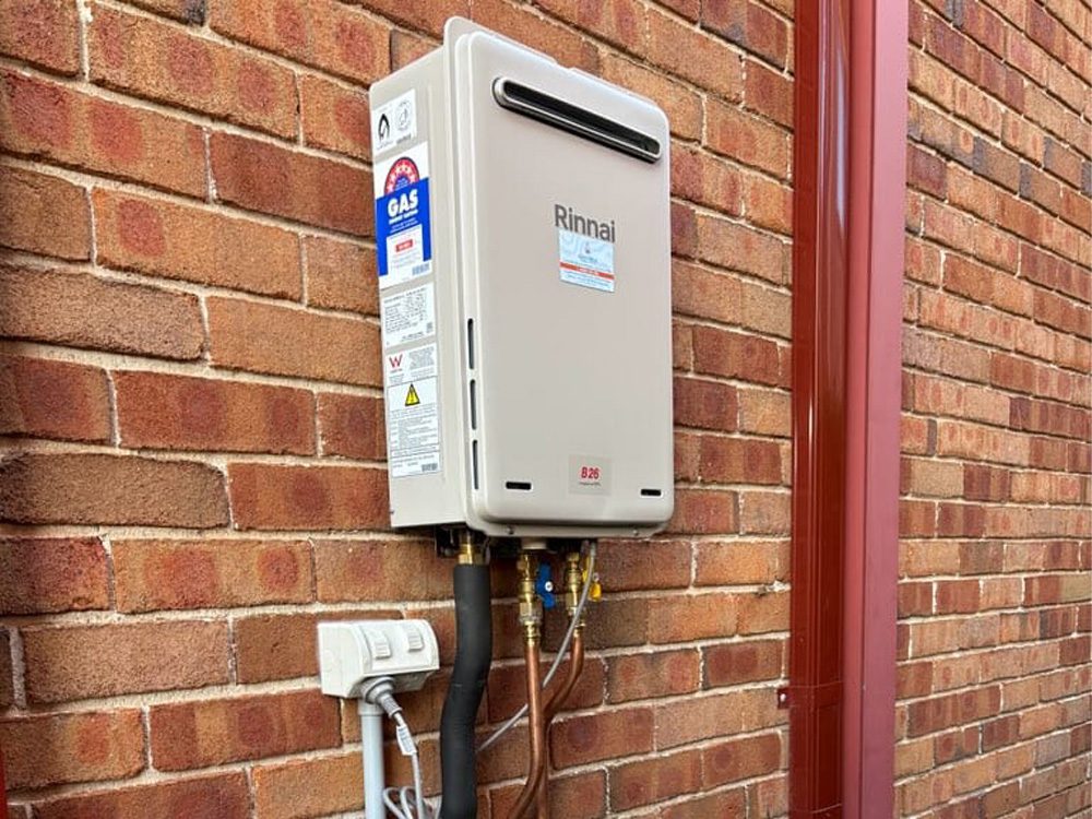 Rinnai gas continuous-flow hot water unit installed on a brick wall