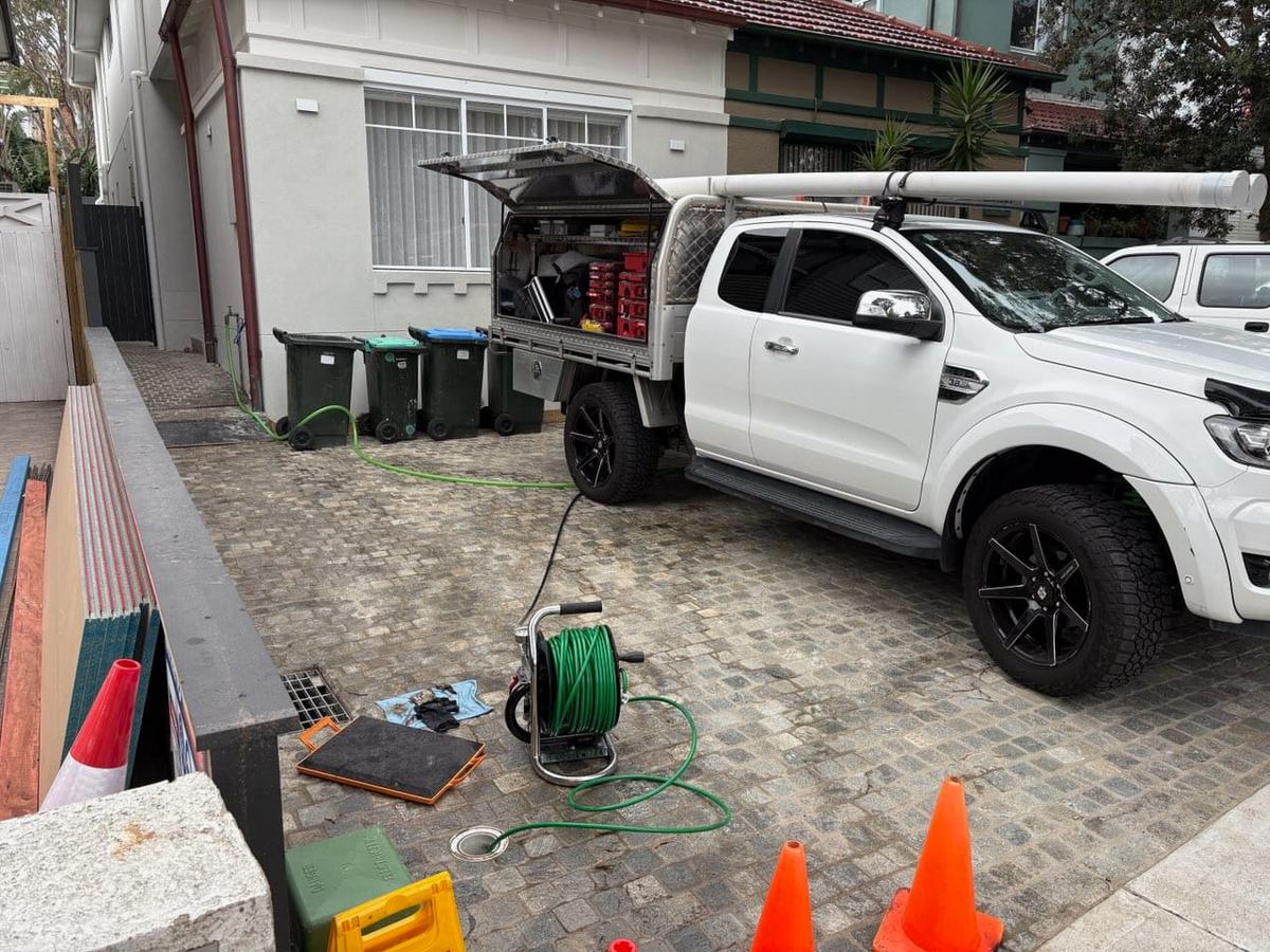 Alex Ingle Plumbing ute and drain-camera gear set up at a managed residential property